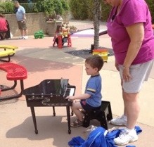 kid playing toy piano