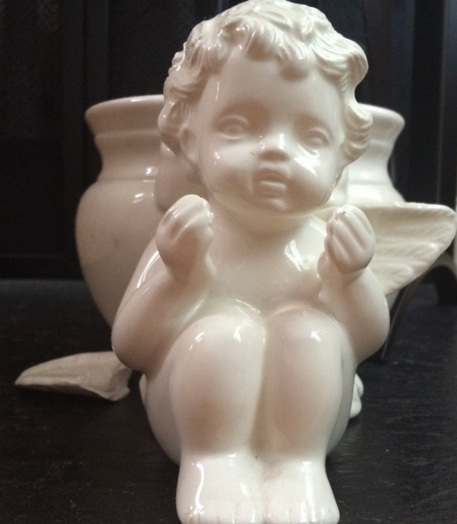 cherub pot with a wing broken off