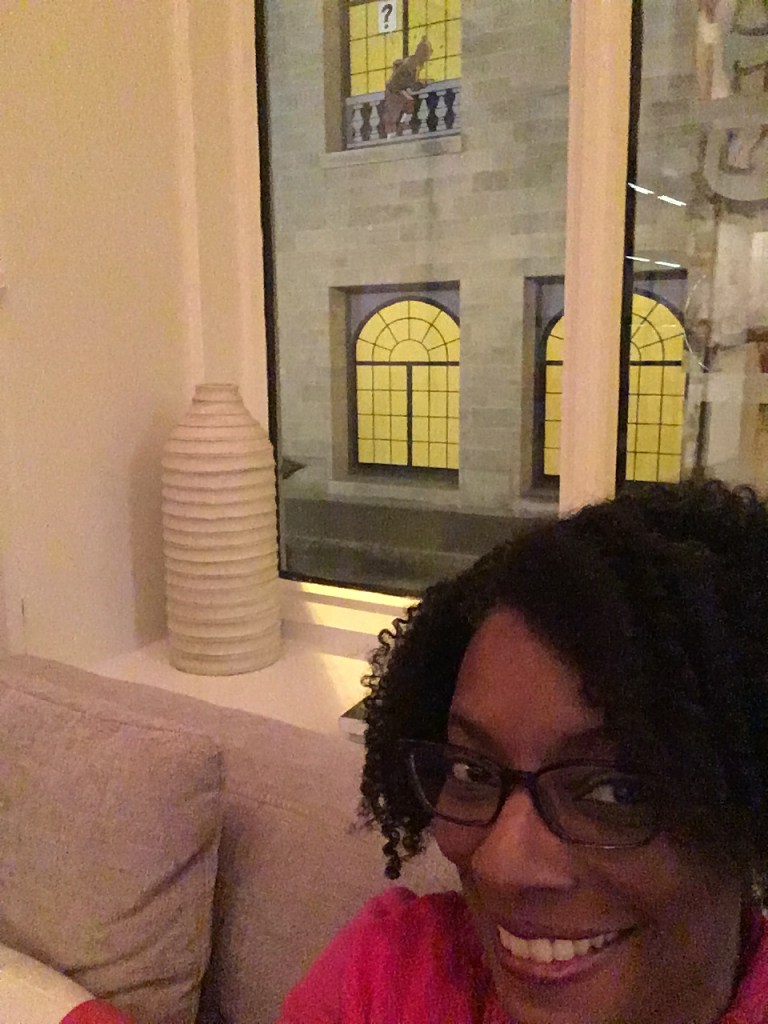 cartoon character climbs in window at museum across the street