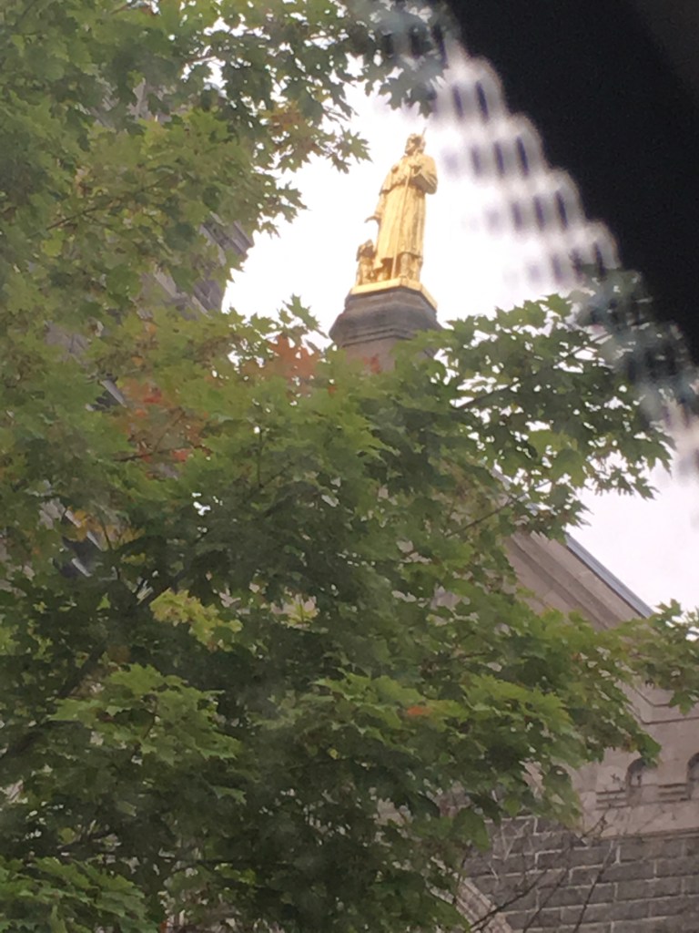 Gold statue of Saint Roch and his dog atop Saint Roch Church