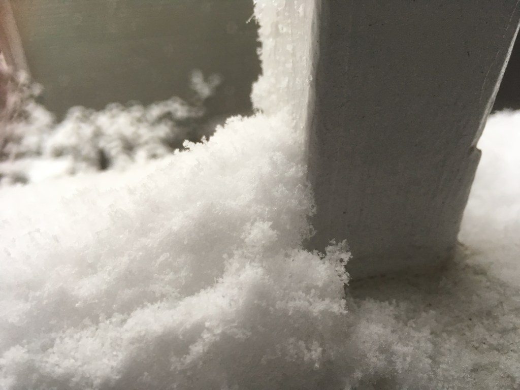 fresh snow on a rail