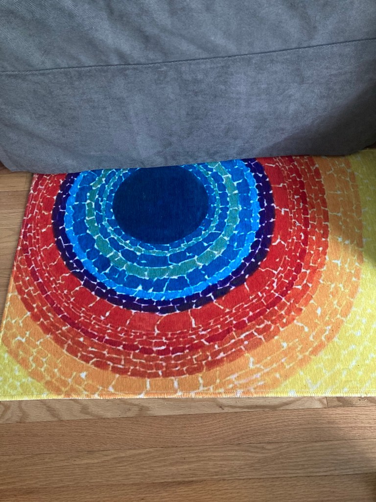 Small area rug in office featuring the artwork “The Eclipse.”