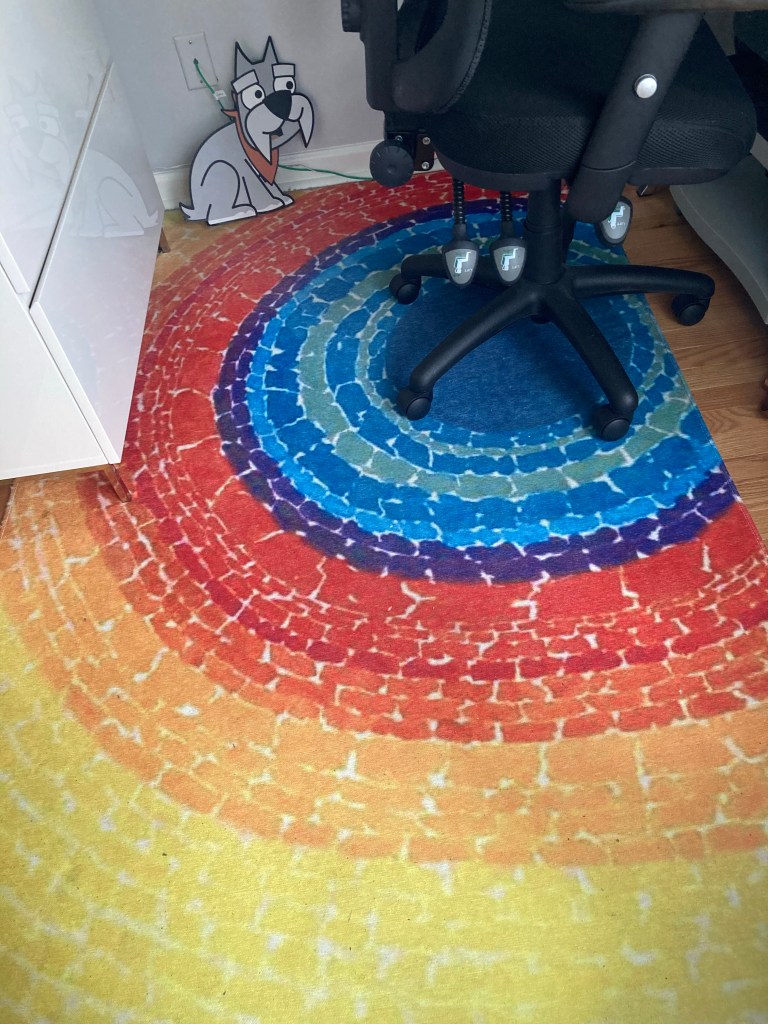 Large area rug in office featuring the artwork “The Eclipse.”